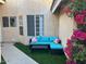 Cozy courtyard featuring artificial turf, outdoor seating, and mature foliage at 6734 S Brittany S Ln, Tempe, AZ 85283