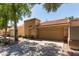 A well maintained home exterior with a two car garage and front yard trees at 6734 S Brittany S Ln, Tempe, AZ 85283