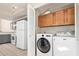 Laundry room with washer, dryer, and added cabinet space at 6734 S Brittany S Ln, Tempe, AZ 85283