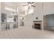 Open-concept living room with a fireplace, neutral tile flooring and ample natural light at 6734 S Brittany S Ln, Tempe, AZ 85283