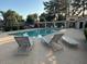 Community pool area featuring lounge chairs for residents and a covered patio area for relaxing by the water at 6734 S Brittany S Ln, Tempe, AZ 85283