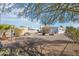 Backyard area featuring gravel landscaping, additional sheds, and low-maintenance charm at 690 S 92Nd Pl, Mesa, AZ 85208
