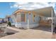 Single-story home with covered parking and landscaped yard at 690 S 92Nd Pl, Mesa, AZ 85208