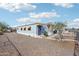 A charming single-story home featuring manicured landscaping and secure fencing at 690 S 92Nd Pl, Mesa, AZ 85208