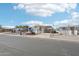 Charming blue manufactured home with covered parking and chain-link fence in a well-maintained community at 690 S 92Nd Pl, Mesa, AZ 85208