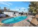 Backyard showcasing a large pool with a lounging area and mature landscaping at 6913 W Wilshire Dr, Phoenix, AZ 85035