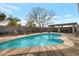 Refreshing backyard pool with a spacious deck, comfortable seating, and a serene outdoor ambiance at 6913 W Wilshire Dr, Phoenix, AZ 85035