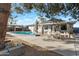 Spacious backyard with a large pool, patio area, and mature trees at 6913 W Wilshire Dr, Phoenix, AZ 85035