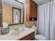 Functional bathroom with a vanity, mirror, cabinet, and shower with curtain at 6913 W Wilshire Dr, Phoenix, AZ 85035