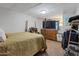 Cozy bedroom with a unique bed frame, TV, and soft carpet at 6913 W Wilshire Dr, Phoenix, AZ 85035
