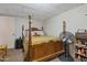 Bedroom featuring a wooden framed bed and a collection of personal items at 6913 W Wilshire Dr, Phoenix, AZ 85035