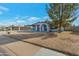 Inviting single-story home featuring a covered entrance, lush trees, and a manicured lawn at 6913 W Wilshire Dr, Phoenix, AZ 85035