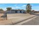 Charming single-story home with a long driveway, covered carport, and a well-maintained front yard at 6913 W Wilshire Dr, Phoenix, AZ 85035