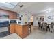 Well-equipped kitchen with granite counters, a black appliance package, and seamlessly flowing into the dining area at 6913 W Wilshire Dr, Phoenix, AZ 85035