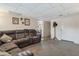 Spacious living room with comfortable brown sectional sofa and neutral carpet at 6913 W Wilshire Dr, Phoenix, AZ 85035