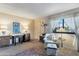 Cozy living room with a chair, two tables and a large window for natural light at 6913 W Wilshire Dr, Phoenix, AZ 85035