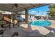 Pool area with comfortable seating, a grill, and palm trees at 6913 W Wilshire Dr, Phoenix, AZ 85035