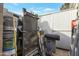 Messy storage area containing paint, equipment and ladders at 6913 W Wilshire Dr, Phoenix, AZ 85035