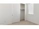 Bright bedroom featuring a closet with sliding doors and a window that provides natural light at 7425 W Buckhorn Trl, Peoria, AZ 85383