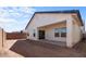 Spacious backyard features covered patio, block fence, and space for landscaping and outdoor entertaining at 7664 W Minton St, Laveen, AZ 85339