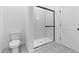 Contemporary bathroom with modern shower, glass door, elegant floor tiles, and toilet at 7664 W Minton St, Laveen, AZ 85339