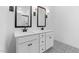 Modern bathroom features double sink vanity, sleek mirrors, and patterned tile floor at 7664 W Minton St, Laveen, AZ 85339