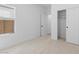 Bright bedroom with a window, a closet with sliding doors, and neutral carpet flooring at 7664 W Minton St, Laveen, AZ 85339