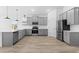 Contemporary kitchen featuring gray cabinets, stainless steel appliances, and wood-look tile flooring at 7664 W Minton St, Laveen, AZ 85339