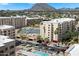 Stunning aerial view of Scottsdale property with pool, tennis court, and mountain views at 7840 E Camelback Rd # 111, Scottsdale, AZ 85251