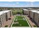 Aerial view of the building complex featuring landscaped courtyard and views of distant cityscape at 7840 E Camelback Rd # 111, Scottsdale, AZ 85251