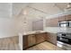 Open concept kitchen with stainless steel appliances and modern cabinets at 7840 E Camelback Rd # 111, Scottsdale, AZ 85251