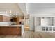 Modern open concept kitchen with stainless steel appliances, white countertops, and wooden cabinets at 7840 E Camelback Rd # 111, Scottsdale, AZ 85251