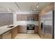 Modern kitchen with stainless steel appliances and wood cabinets at 7840 E Camelback Rd # 111, Scottsdale, AZ 85251