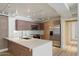Modern kitchen with stainless steel appliances, white countertops, and wooden cabinets at 7840 E Camelback Rd # 111, Scottsdale, AZ 85251