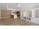 Bright and airy living room featuring wood floors and custom built-in shelving at 7840 E Camelback Rd # 111, Scottsdale, AZ 85251