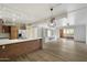 Open concept living room with kitchen, stainless steel appliances, and modern built-in shelving at 7840 E Camelback Rd # 111, Scottsdale, AZ 85251