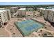 Overhead shot of tennis courts, walkways, landscaping, and surrounding apartment buildings at 7840 E Camelback Rd # 111, Scottsdale, AZ 85251