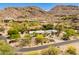 Breathtaking aerial view of white home nestled in desert landscape with mountain backdrop at 7921 N 54Th St, Paradise Valley, AZ 85253