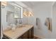 Bathroom featuring a large mirror and custom vanity with stone countertop at 7921 N 54Th St, Paradise Valley, AZ 85253