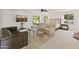 Bright bedroom with queen bed, TV, sitting area, and sliding glass door to the outdoors at 7921 N 54Th St, Paradise Valley, AZ 85253