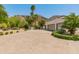 Long private driveway leading to a three car garage with desert landscaping, mountain views, and mature trees at 7921 N 54Th St, Paradise Valley, AZ 85253