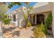 Inviting front entrance with a custom wood door and a well-landscaped courtyard with mature desert landscaping at 7921 N 54Th St, Paradise Valley, AZ 85253