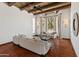 Inviting living room with beamed ceilings, tile flooring, and bright bay windows at 7921 N 54Th St, Paradise Valley, AZ 85253