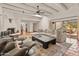 Open-concept living room with a fireplace, beams, and access to a patio at 7921 N 54Th St, Paradise Valley, AZ 85253