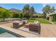 Inviting outdoor patio with cushioned seating area, pool, and scenic mountain views at 7921 N 54Th St, Paradise Valley, AZ 85253