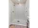 Shower featuring glass enclosure, mosaic tile accents, and rainfall shower head at 7921 N 54Th St, Paradise Valley, AZ 85253