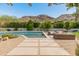 Backyard swimming pool with lounge seating, complemented by desert landscaping and scenic mountain views at 7921 N 54Th St, Paradise Valley, AZ 85253