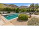 Backyard swimming pool with desert landscaping and scenic mountain views, creating a relaxing outdoor living space at 7921 N 54Th St, Paradise Valley, AZ 85253