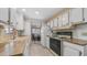 Efficient kitchen layout with white cabinets, wood countertops, and essential appliances at 8103 E Southern Ave # 154, Mesa, AZ 85209