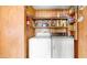 Practical laundry room with a washer and dryer, storage shelves, and wood paneling at 8103 E Southern Ave # 154, Mesa, AZ 85209